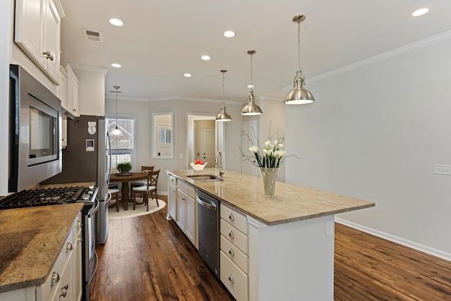 kitchen featuring a sink, appliances with stainless steel finishes, dark wood-style floors, visible vents, and ornamental molding