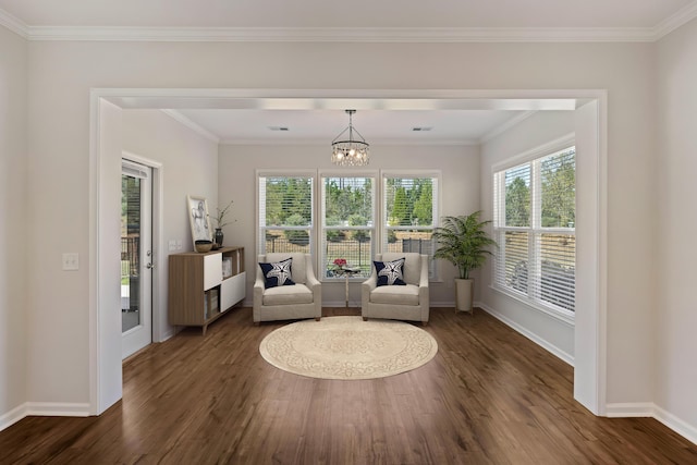 sitting room featuring baseboards, an inviting chandelier, crown molding, and dark wood finished floors