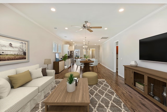 living area with visible vents, baseboards, ornamental molding, recessed lighting, and dark wood-type flooring
