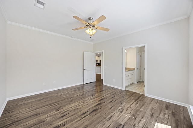 unfurnished bedroom featuring wood finished floors, crown molding, baseboards, and visible vents