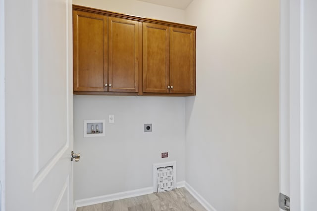washroom with cabinet space, baseboards, electric dryer hookup, and washer hookup