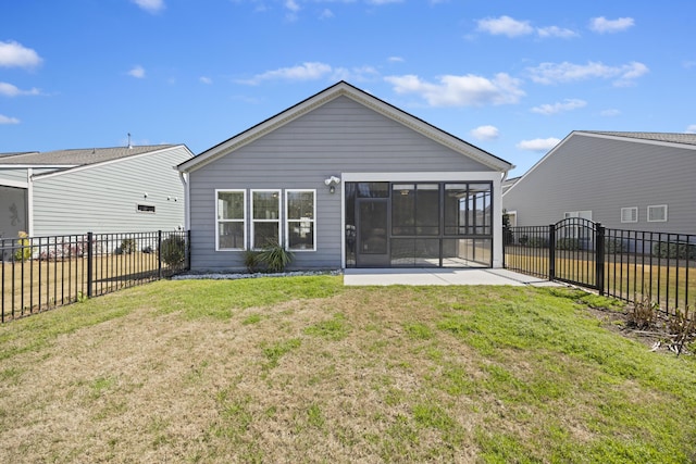 back of house featuring a fenced backyard, a lawn, and a sunroom
