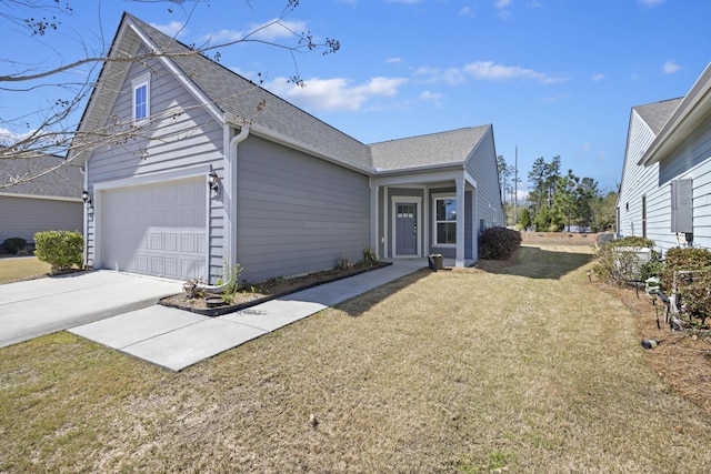 view of front of property with a front yard, a shingled roof, and concrete driveway
