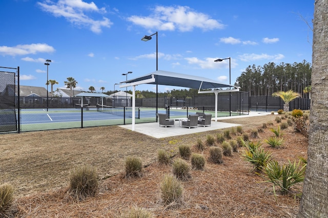 view of sport court featuring fence