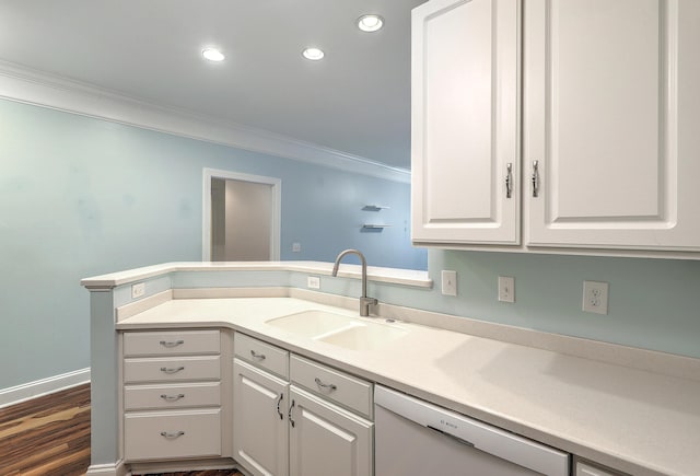 kitchen with a sink, white dishwasher, ornamental molding, white cabinetry, and recessed lighting