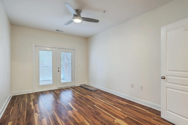 empty room with french doors, dark wood-style floors, baseboards, and a ceiling fan