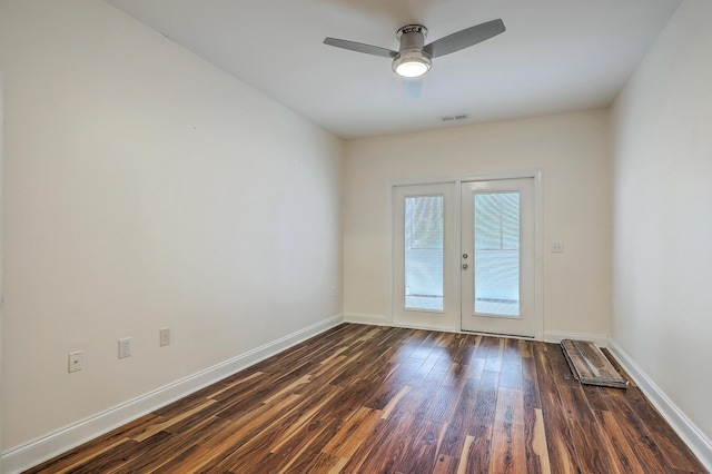 unfurnished room with dark wood-style floors, baseboards, french doors, and a ceiling fan