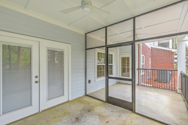 unfurnished sunroom with a ceiling fan