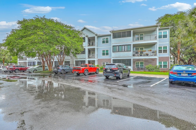 view of building exterior featuring uncovered parking