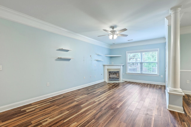 unfurnished living room with decorative columns, a ceiling fan, crown molding, dark wood-style floors, and a fireplace with flush hearth