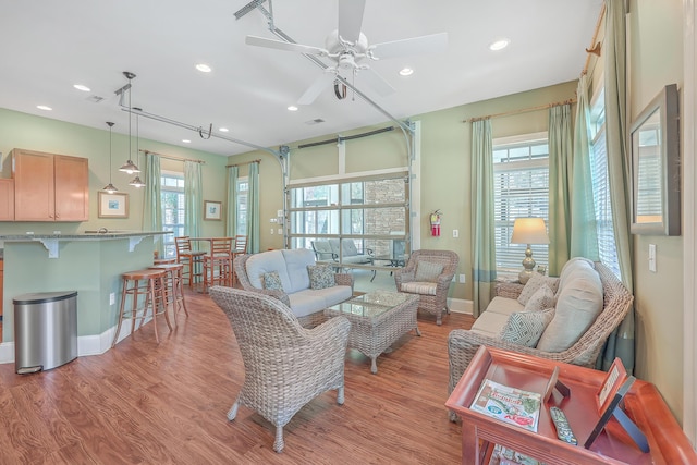 living area featuring ceiling fan, recessed lighting, light wood finished floors, and baseboards
