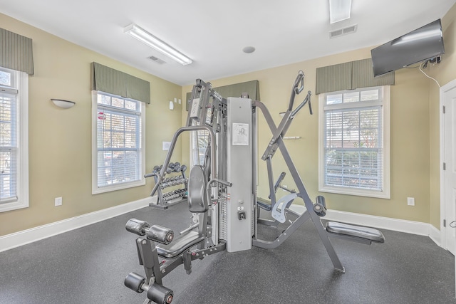 exercise area featuring healthy amount of natural light and baseboards