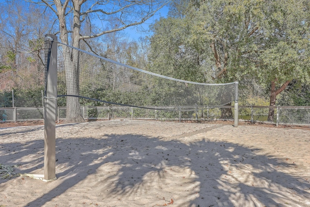 view of home's community featuring volleyball court and fence