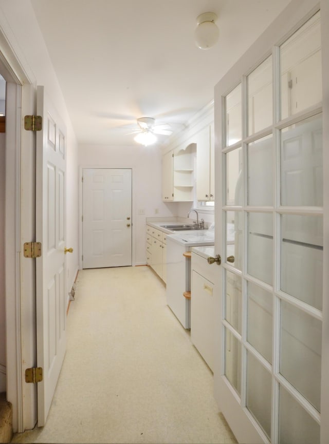 interior space featuring light countertops, white cabinetry, a sink, and open shelves