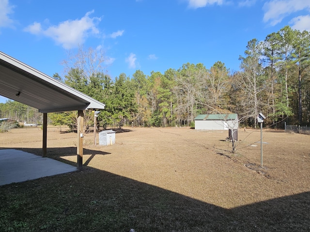 view of yard with an outbuilding and a patio