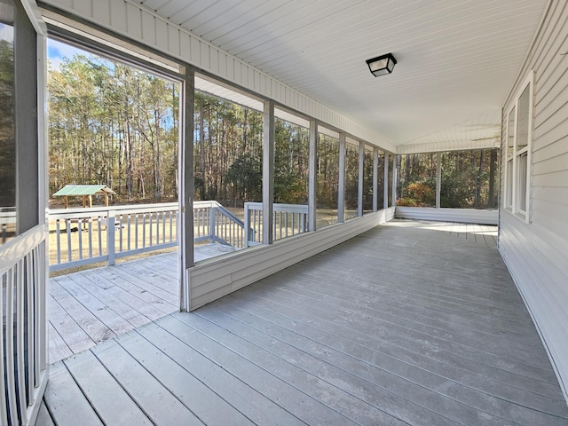 unfurnished sunroom with vaulted ceiling and a healthy amount of sunlight