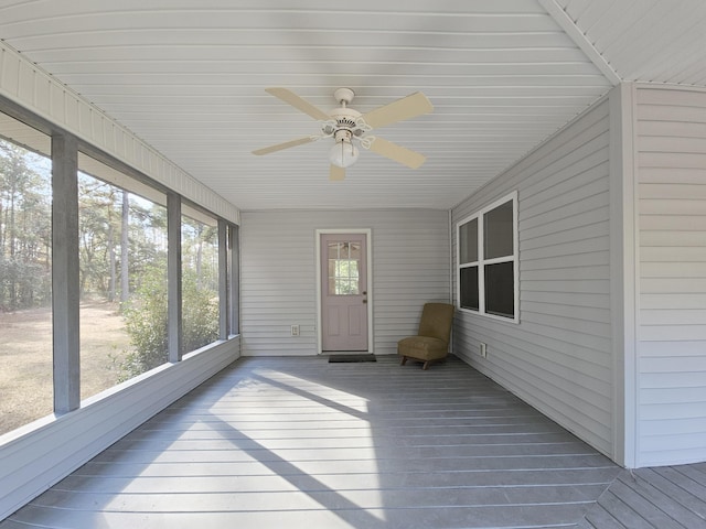 unfurnished sunroom featuring a ceiling fan