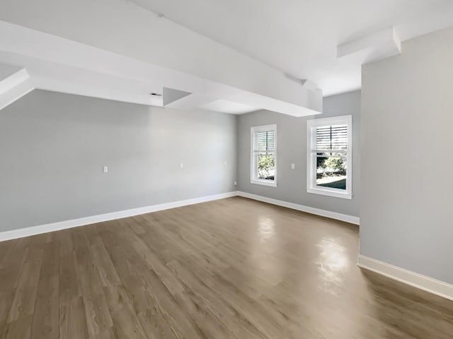 unfurnished room with dark hardwood / wood-style flooring