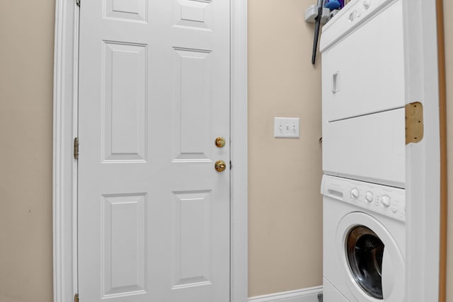 washroom featuring stacked washer / dryer