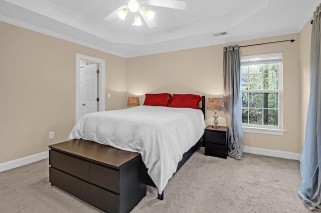 bedroom with light carpet, a raised ceiling, ceiling fan, and crown molding