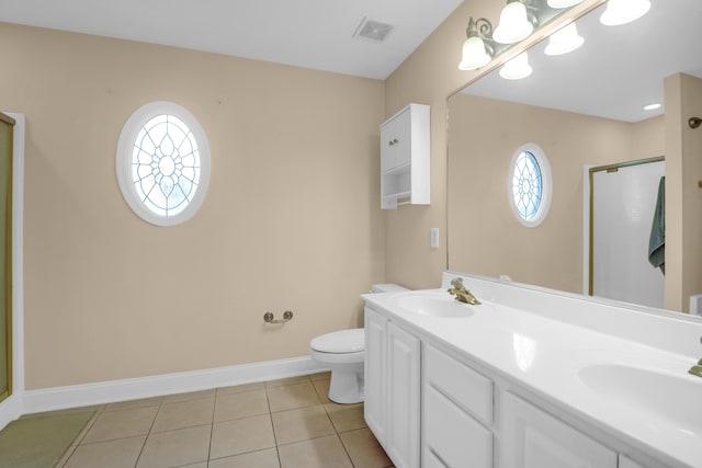 bathroom featuring toilet, vanity, tile patterned floors, and an enclosed shower