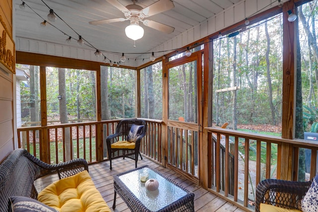 sunroom / solarium featuring ceiling fan