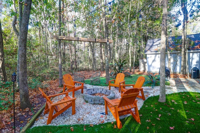 view of yard featuring a patio area and an outdoor fire pit