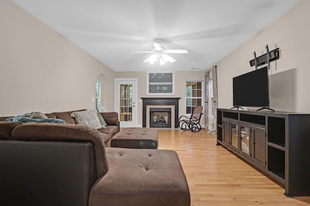 living room featuring ceiling fan and light hardwood / wood-style floors