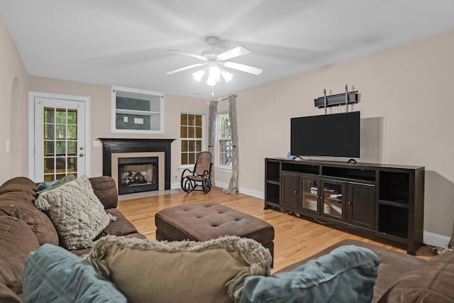 living room with hardwood / wood-style floors, a wealth of natural light, and ceiling fan