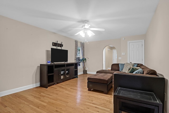 living room featuring ceiling fan and wood-type flooring