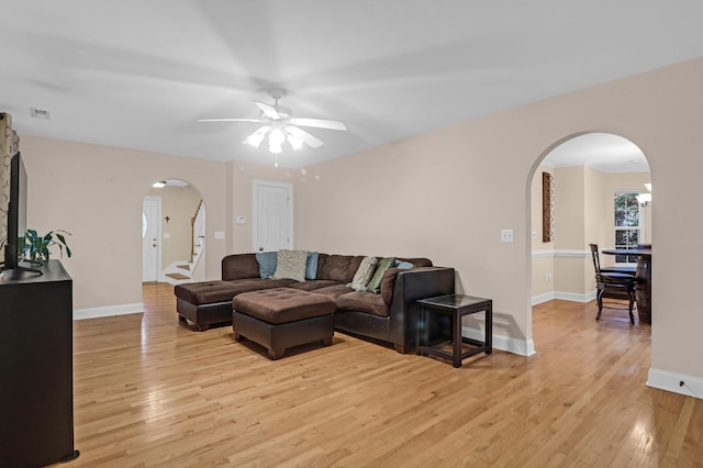 living room featuring ceiling fan and light hardwood / wood-style flooring