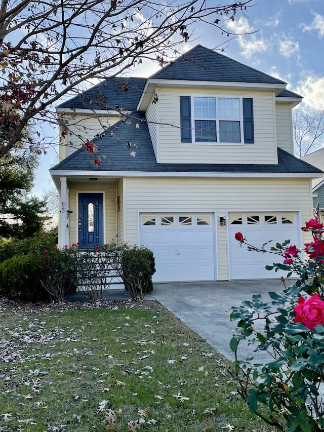 front facade featuring a garage and a front yard