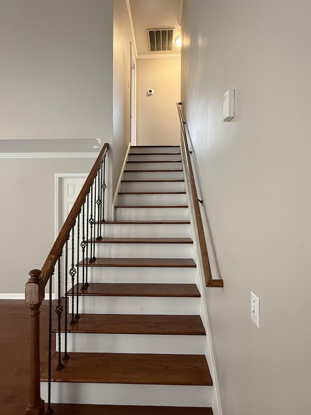 staircase featuring wood-type flooring