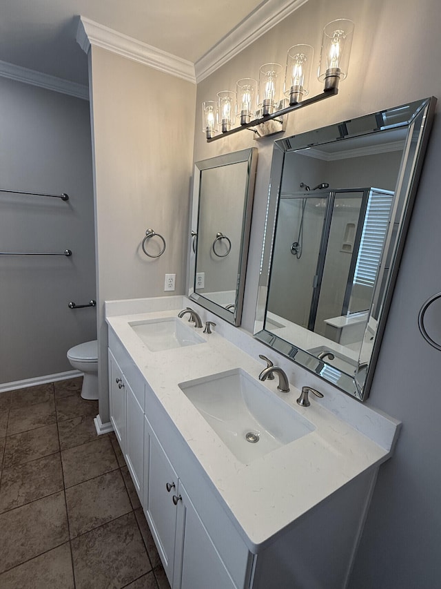 bathroom with vanity, ornamental molding, a shower with shower door, tile patterned floors, and toilet