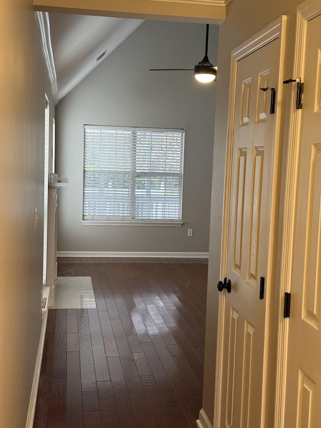 unfurnished room featuring vaulted ceiling, ceiling fan, and dark hardwood / wood-style flooring