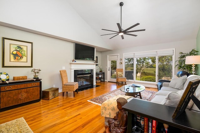 living room featuring ceiling fan, light hardwood / wood-style flooring, and high vaulted ceiling