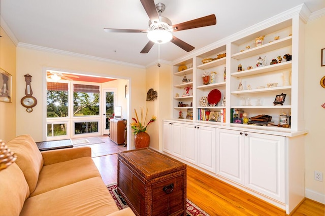 living room featuring light hardwood / wood-style floors, ceiling fan, and crown molding