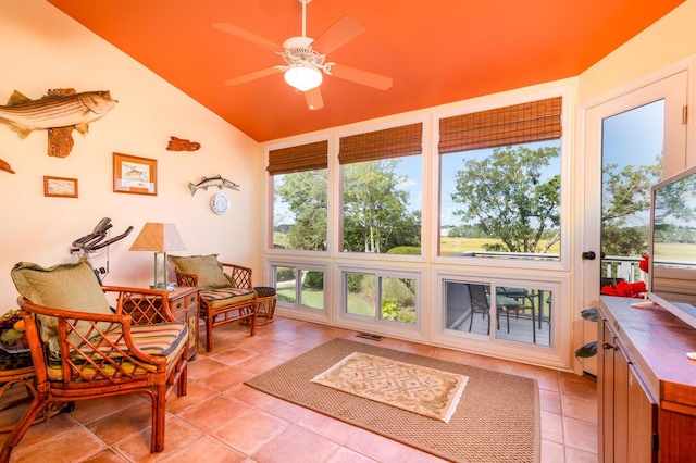 sunroom featuring vaulted ceiling and ceiling fan