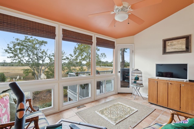 sunroom featuring ceiling fan and lofted ceiling