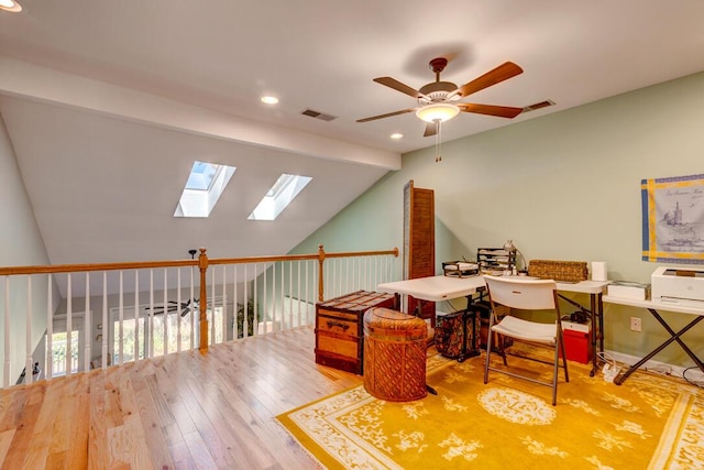 office space featuring hardwood / wood-style flooring, ceiling fan, a wealth of natural light, and vaulted ceiling