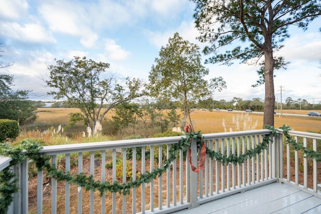 wooden deck featuring a rural view