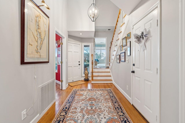 entrance foyer featuring light hardwood / wood-style floors and an inviting chandelier