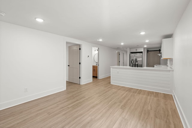 unfurnished living room featuring light hardwood / wood-style flooring