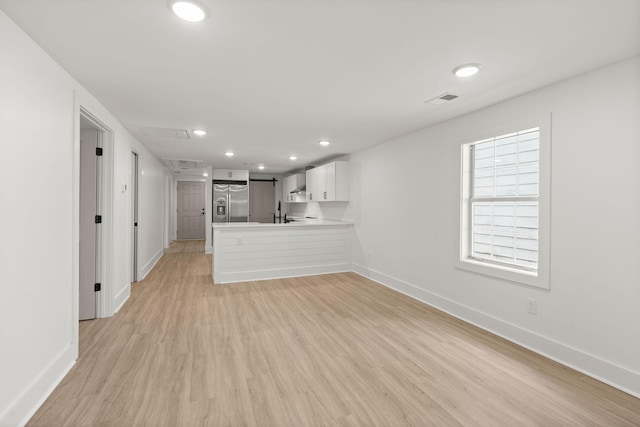 unfurnished living room with light wood-type flooring