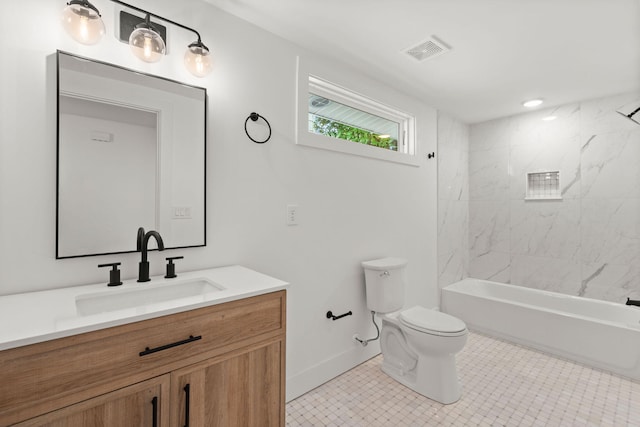 full bathroom featuring vanity, toilet, and tiled shower / bath