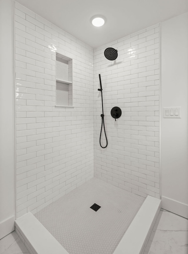 bathroom with a tile shower