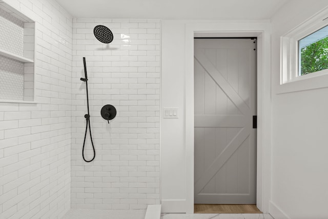 bathroom with tiled shower