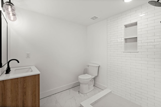 bathroom with vanity, toilet, and walk in shower