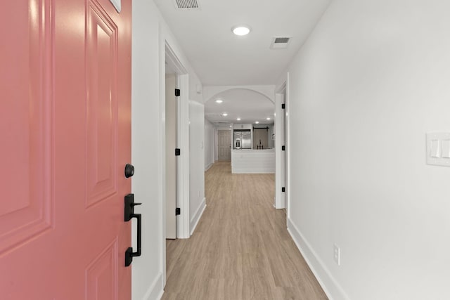 corridor with light hardwood / wood-style flooring