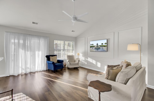 sitting room featuring a ceiling fan, lofted ceiling, dark wood-style flooring, and visible vents